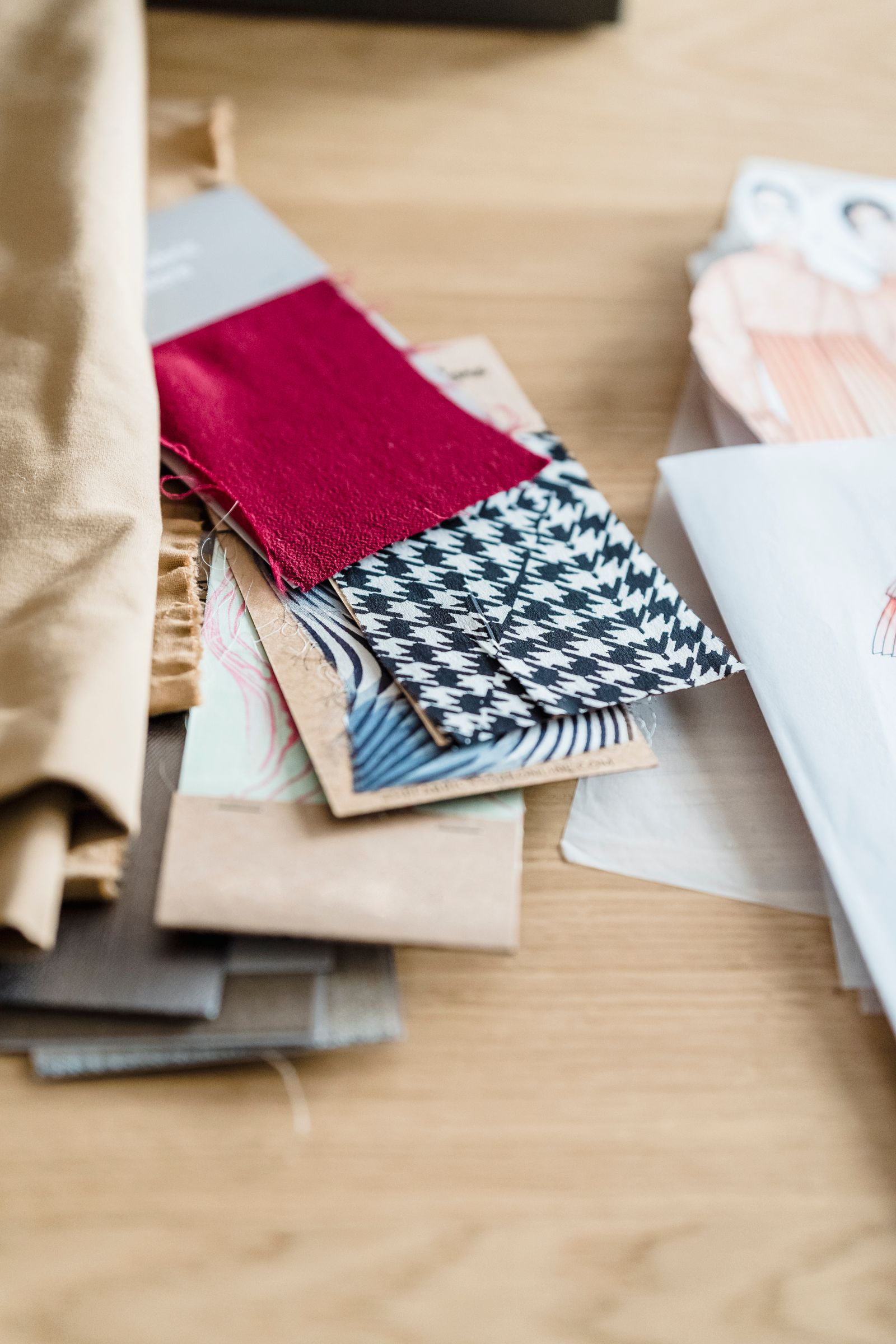 Designer working at a moodboard of fabric swatches, trend tears and colour chips