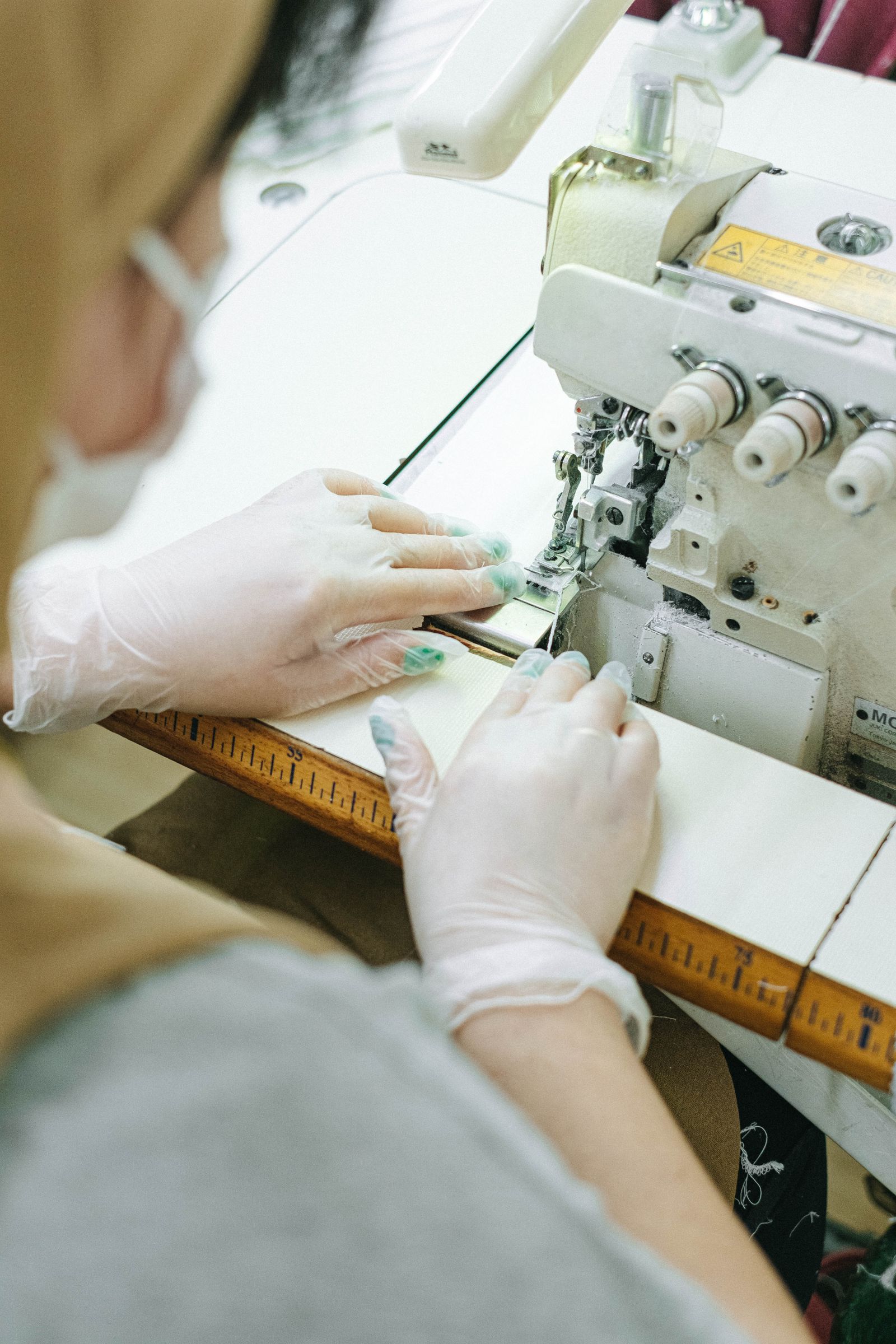 Machinists sewing PPE gowns on the factory floor during the pandemic