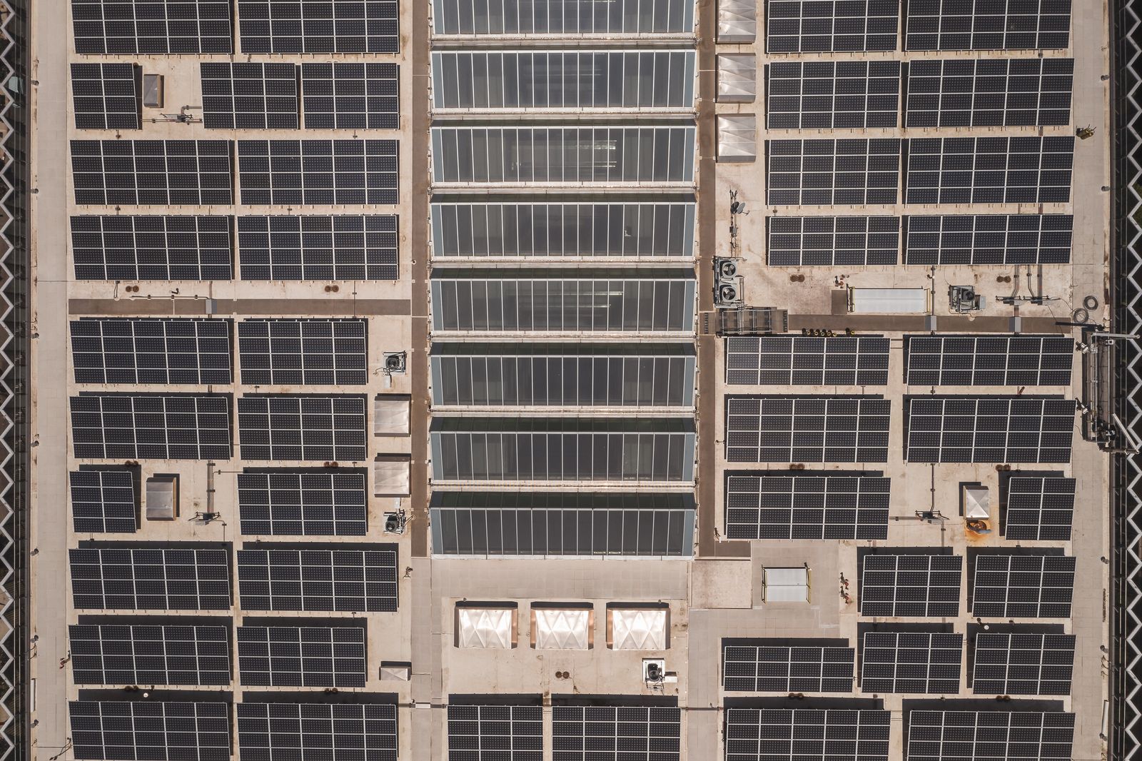 Solar panels on the roof of The Cushion Factory, Knowsley, with sky beyond